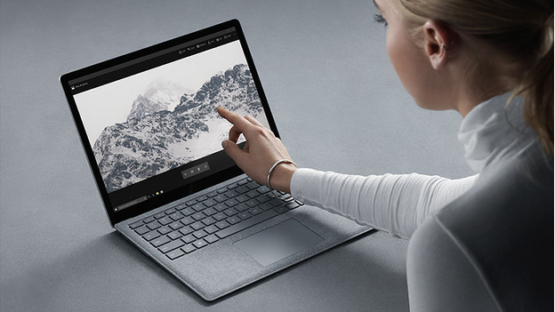 Person tapping the touchscreen Surface Laptop.