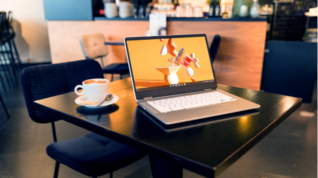 A Chromebook with a cup of coffee.