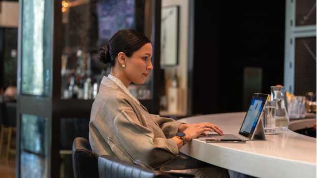 Person working on a Qualcomm laptop.