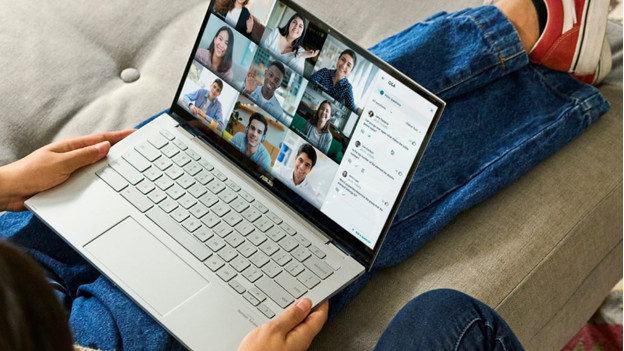 Man sits on couch with Chromebook on lap