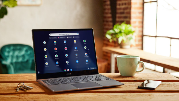 A Chromebook with a cup of coffee.