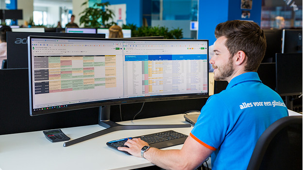 Expert working in his business files via laptop image