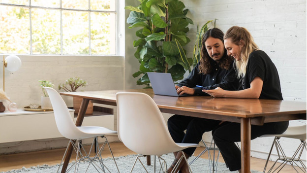 People working with a Qualcomm laptop.