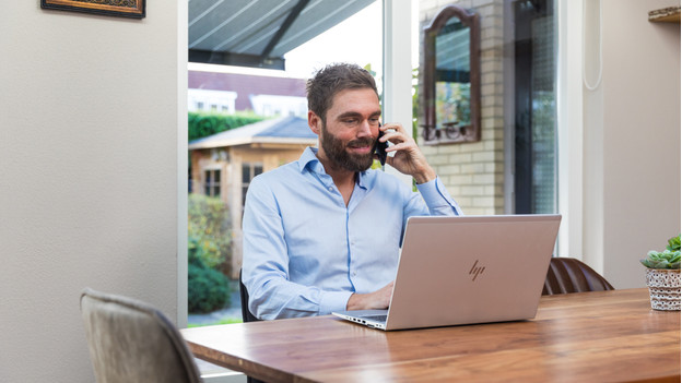 Business user works on their laptop at home