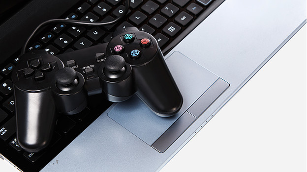 PlayStation controller on laptop keyboard.