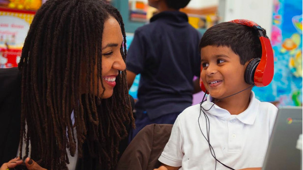 Teacher and child behind Chromebook