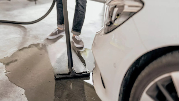 Liquids are being vacuumed with a construction vacuum