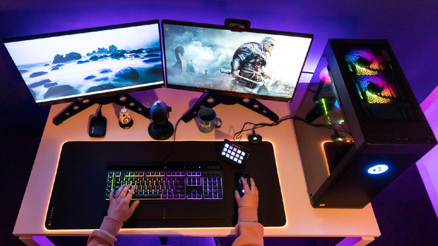 Person plays Apex Legends on HP OMEN gaming desktop setup.