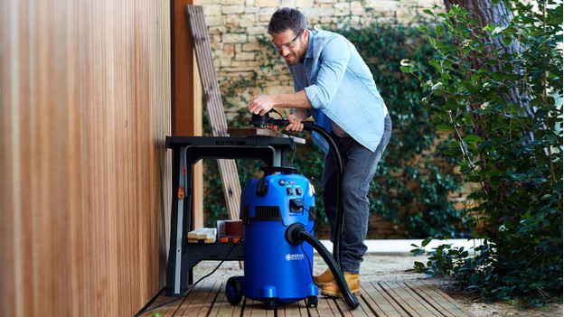 Person uses tools connect to the construction vacuum