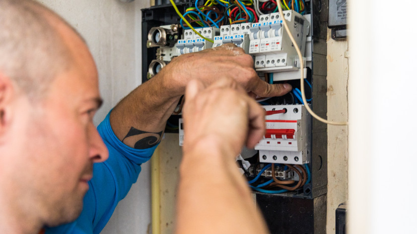 Coolbluer next to a fuse box
