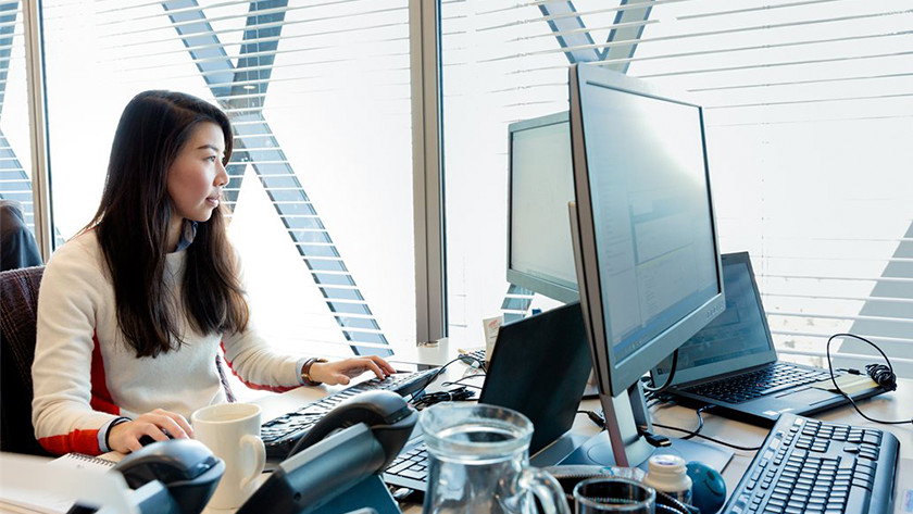Woman working behind a PC in the office.