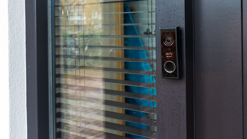 Eufy doorbell hangs next to the door