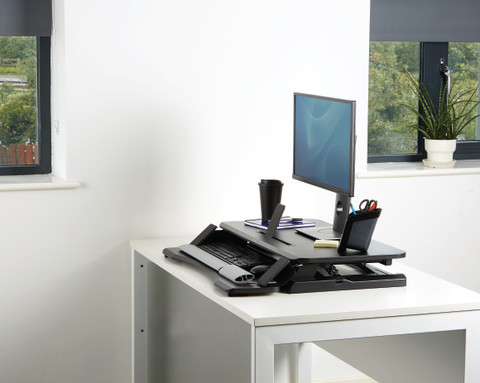 Fellowes Sit-Stand Workstation Black product in use