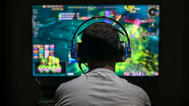 Person playing games with a Dolby Atmos headset