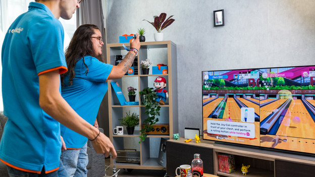 People play Mario Kart on Nintendo Switch.