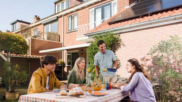 Family having lunch outside in the garden