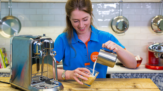 pour milk foam into cup