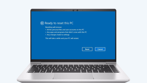 Man tightens screws on a laptop.