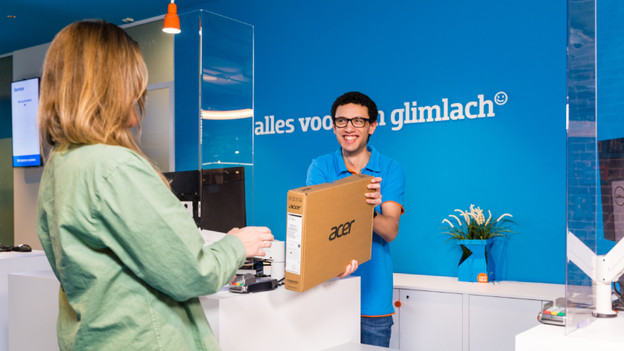 Person giving a new laptop to another person.