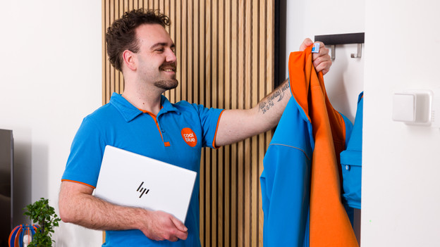 Specialist hangt jas op met EliteBook 1040 onder z'n arm