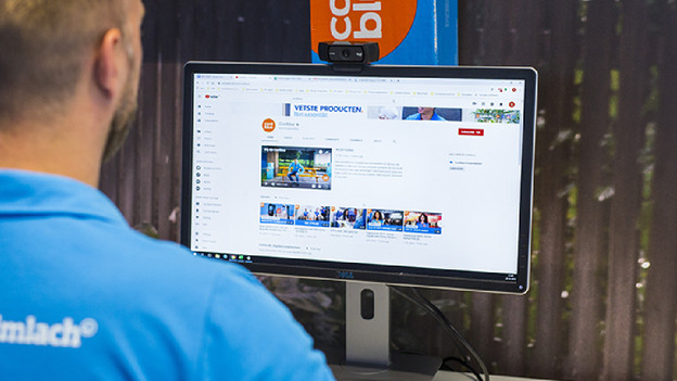 Someone behind a monitor with a webcam