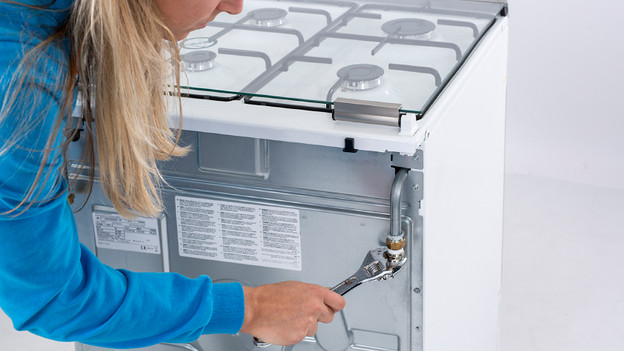 Place a gas connector on a stove