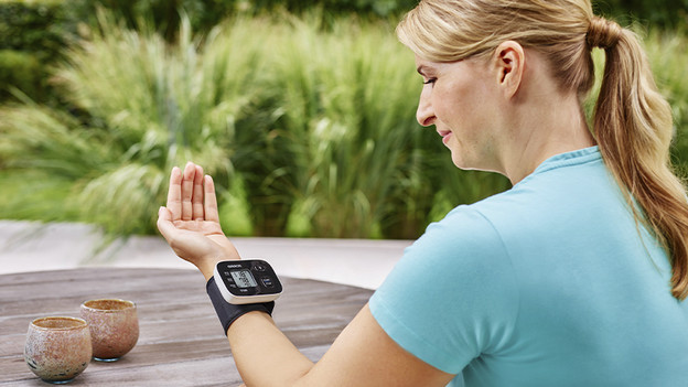 Woman with blood pressure monitor