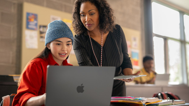 Student and teacher with a MacBook