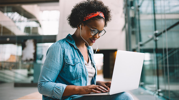 Woman works on a laptop.