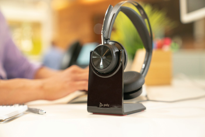 Poly Voyager Focus 2 UC Office Headset + Charging Dock product in use