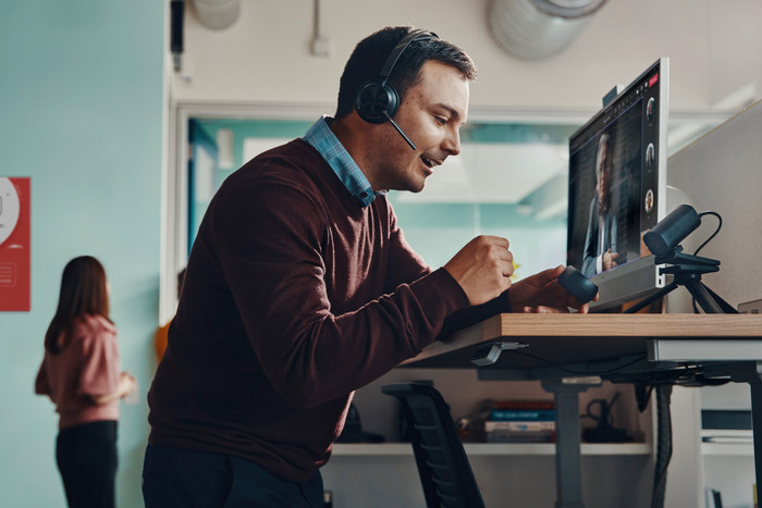 Poly Voyager Focus 2 UC Office Headset + Charging Dock product in use