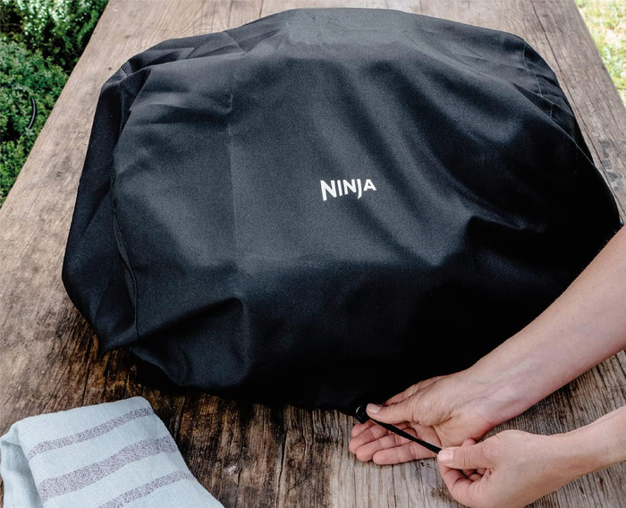 Ninja Woodfire Electric BBQ Grill and Smoker OG850EU Starter Pack product in use